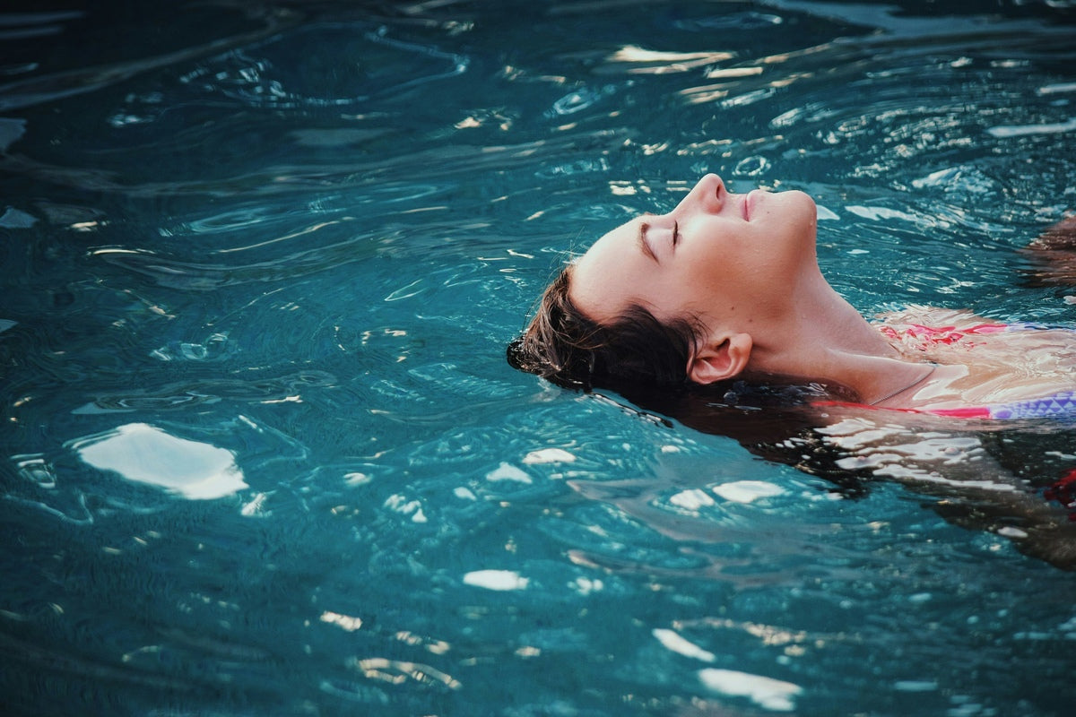 A woman swimming in a saltwater pool.