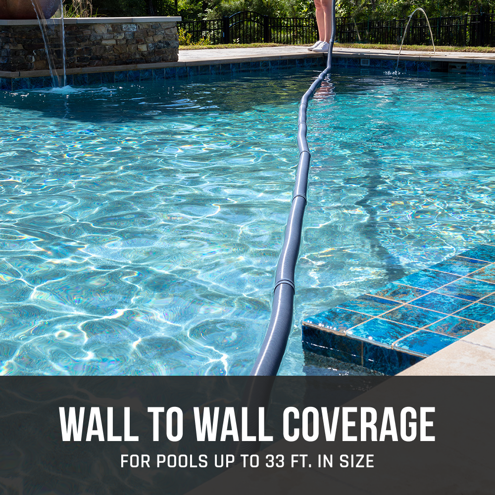 A person places the HAYWARD INDUSTRIES INC. POOLVERG 4 WHL LTD GUNITE Automatic Suction Cleaner W3PVS40GST in a pool, with text stating "Wall to wall coverage for pools up to 33 ft.," highlighting its efficiency.
