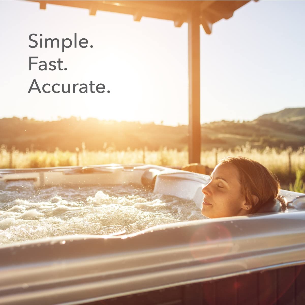 At sunset, a person relaxes in an outdoor hot tub, using Leisure Time Chlorine & Bromine Test Strips (50 Strips | 45006A) by Leisure Time. “Simple. Fast. Accurate.” appears on the image.