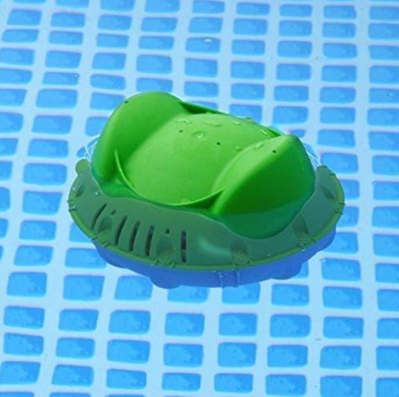 The Frog Flippin Frog Mineral Sanitizer (01-12-8406) by King Tech, a green floating chlorine dispenser with a dual-action system, drifts gracefully in your blue-tiled pool, effortlessly elevating your pool care routine.
