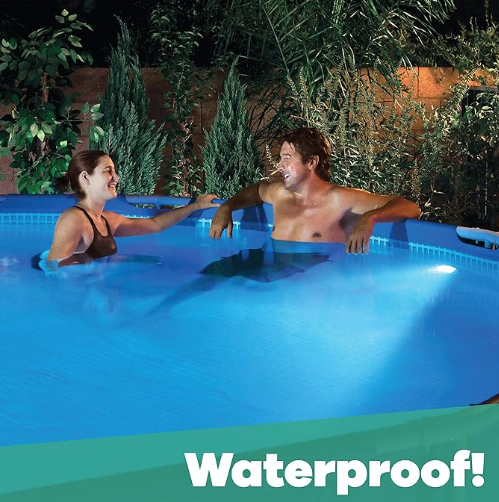 Two people sit and talk in an above-ground pool at night, lit by the GAME Magnetic Pool Wall Light w/ Remote Control. The pool glows with changing colors, and "Waterproof!" appears in bold text at the bottom.