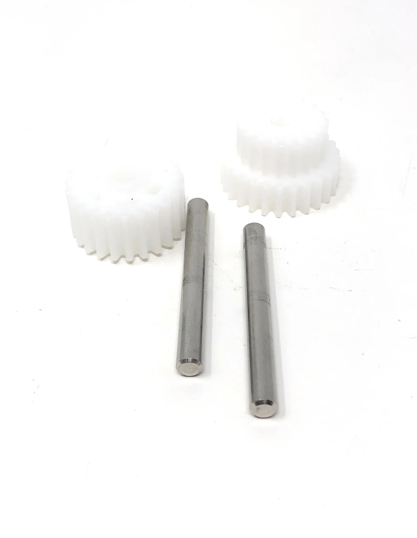 The Pentair Rebel/Warrior Drive Gear Kit (360292) by Pentair includes two white plastic gears and two metal rods, shown on a white surface. Compatible with Pentair Rebel pool cleaners.