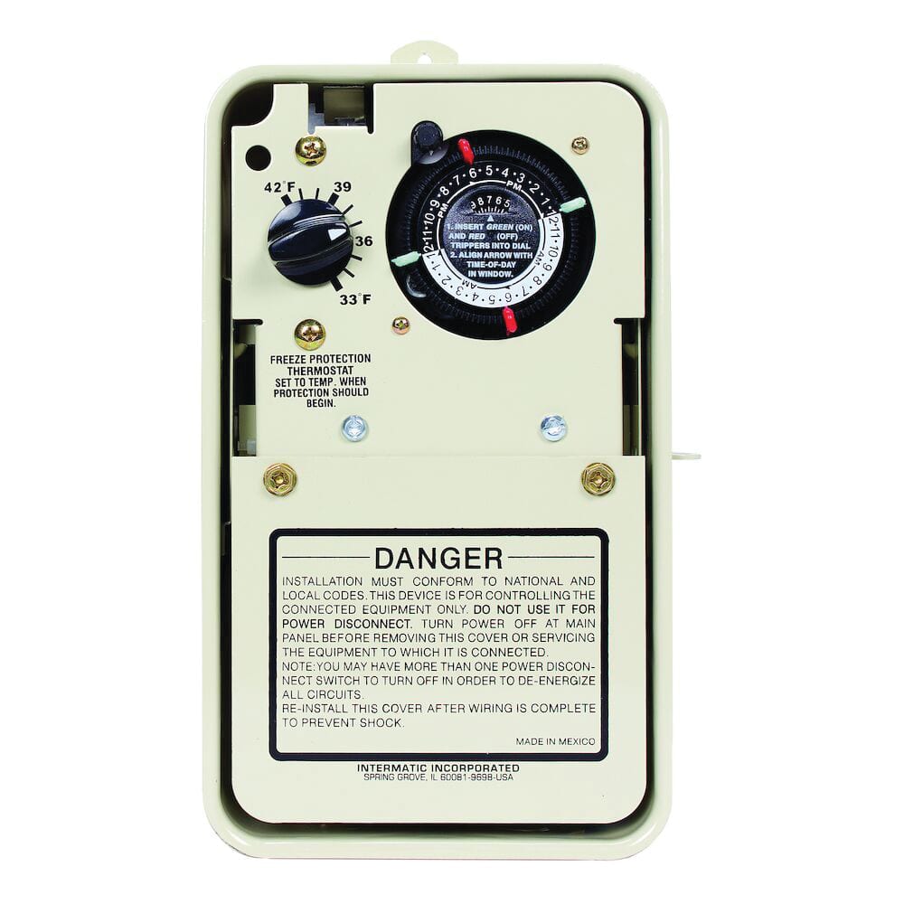 Close-up of the Intermatic ITMPF1103T mechanical timer featuring a black dial with time settings, ideal for pool equipment. A warning label below offers installation/safety instructions in black text on white. Complements any adjustable thermostat for freeze protection. Dimensions: 5.75"x3.625"x9.625".