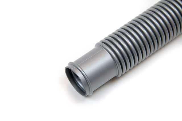 A close-up of a Plastiflex 1-1/2" x 12' gray flexible corrugated pool filter hose with a smooth connector end (FK101112012R), photographed on a white background.