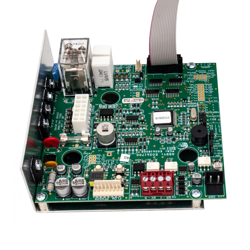 The Jandy Power Interface Board Assembly (R0984100) is a green PCB with electronic components, connectors, and a ribbon cable on a metal base, designed for the Jandy AquaPure Salt Water Pool System.