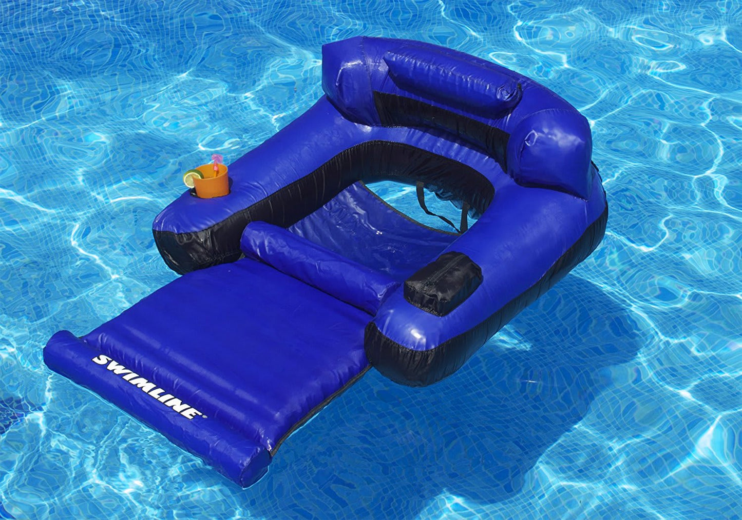 The Swimline Fabric Covered Floating Pool Lounger, Blue/Black (9047), by Swimline, floats effortlessly on clear blue water with its built-in cup holder—perfect for relaxing in style.
