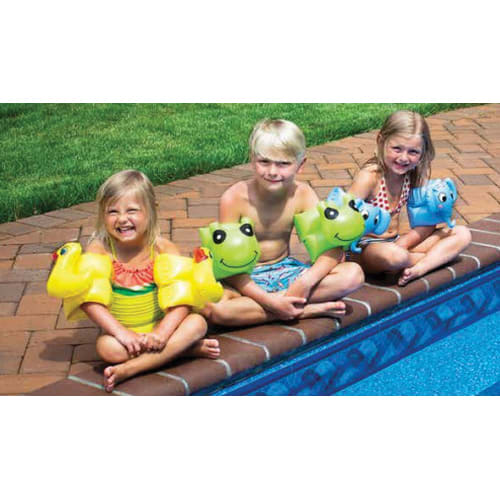 Three kids with Swimline Animal Fun Bands Assortment | 98065 floaties from Swimline sit by the pool edge, smiling brightly on a sunny day.