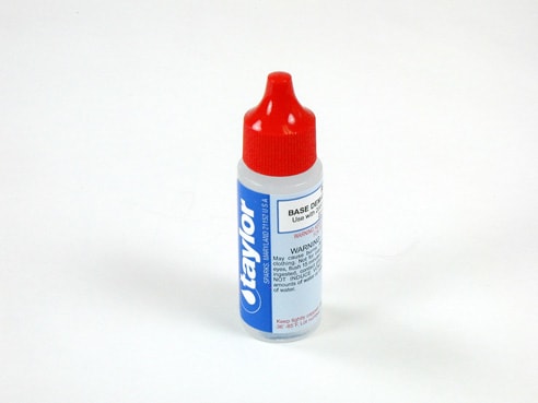 A small .75 oz plastic bottle of Taylor Base Demand Reagent for 2000 Series Kits (R-0006-A-24), featuring a red cap and a blue and white label with the "Taylor" brand, containing liquid for water testing.