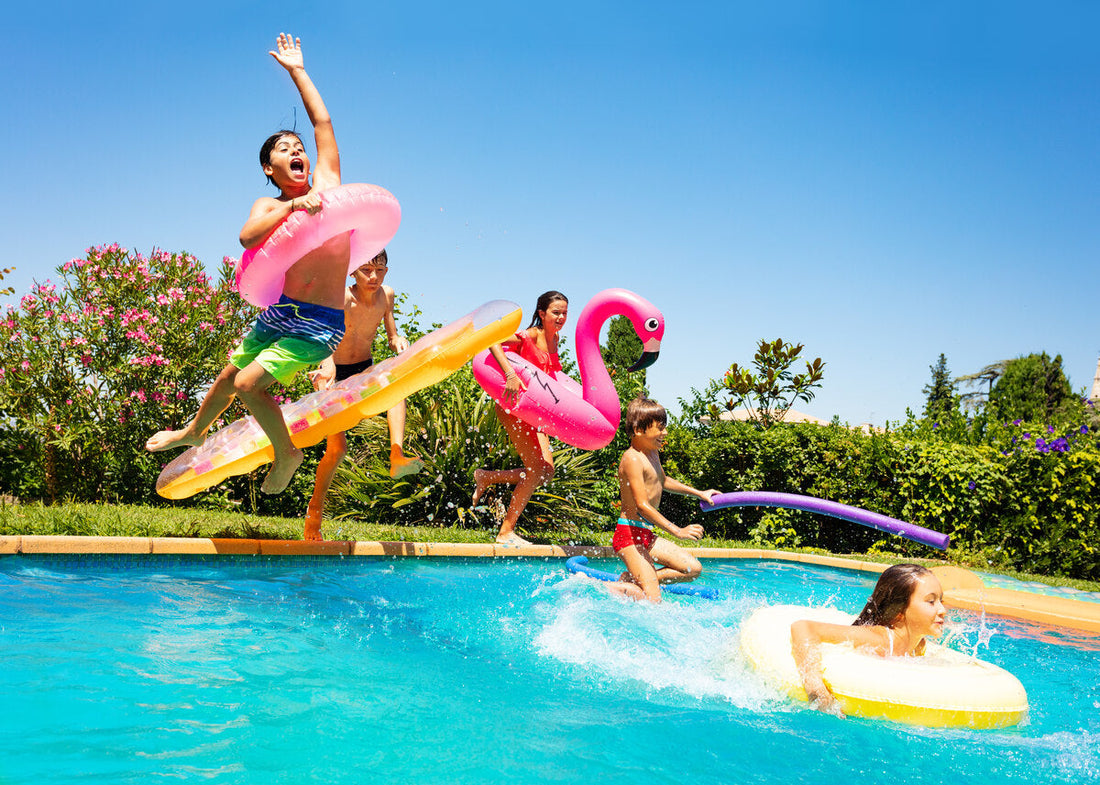 Children jumping into a pool with floats.