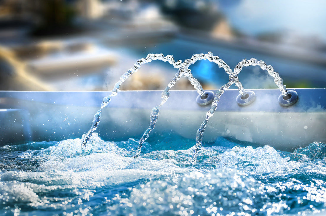 A hot tub with water flowing out of a fountain.