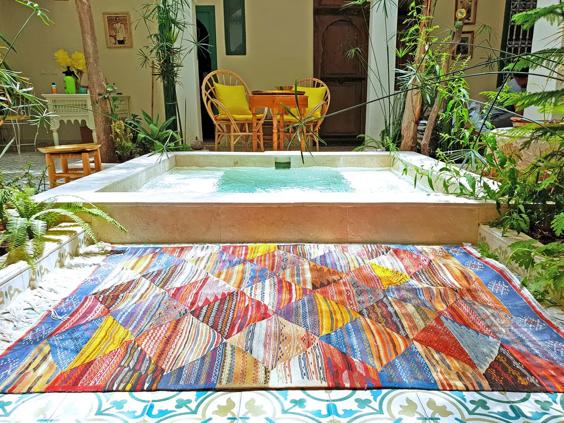 A hot tub with a colorful mat in front of it.