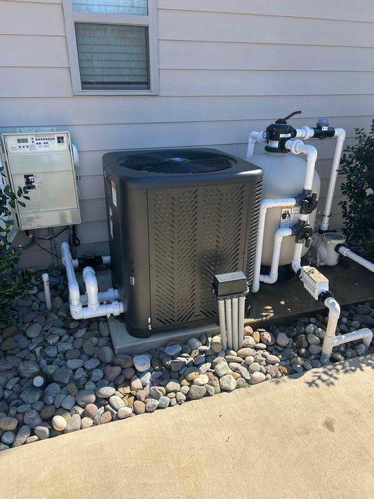 Pool equipment pad with heat pump. 