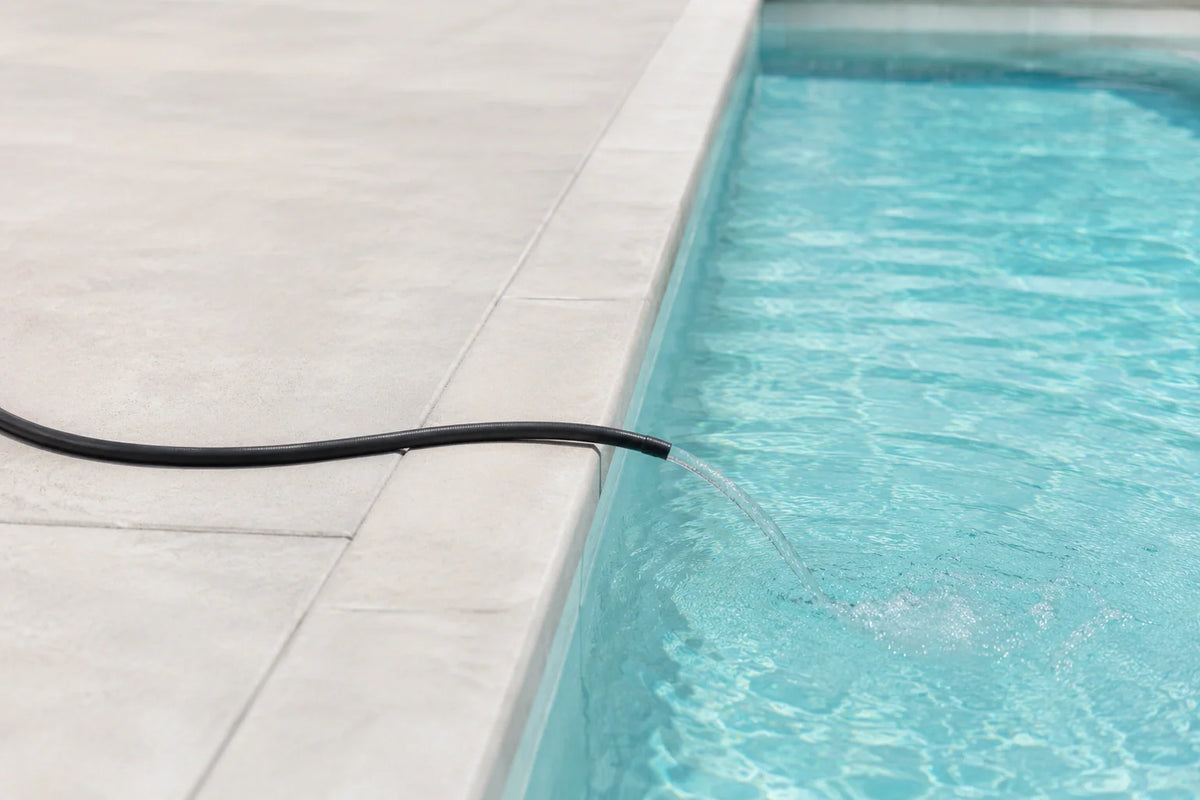 Hose filling a pool with freshwater