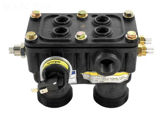 The Pentair MasterTemp 125 Manifold Kit by PENTAIR AQUATIC SYSTEMS is a black rectangular valve block with four top bolts, multiple threaded ports, and side electrical connectors—ideal as a heater manifold component for MasterTemp 125 systems.