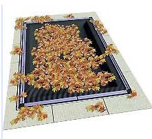 A rectangular pool is covered by the SWIMLINE CORP. 30' x 50' RE LEAFNET COVER, now speckled with dry autumn leaves.