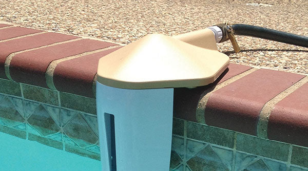 The CMP Aqua Level Portable Auto Leveler by Pool Goods (25604-009-000) is a pool skimmer device that attaches to your inground pool's edge with a hose connection, featuring a tan lid.